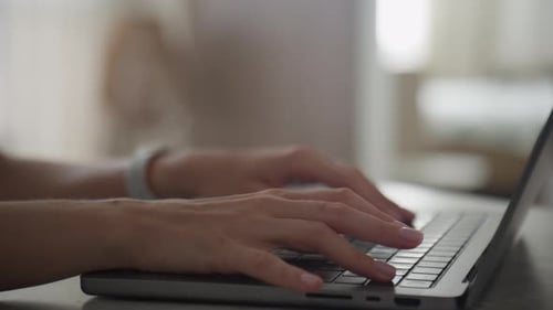 Closeup of Hands Typing on a Laptop Keyboard