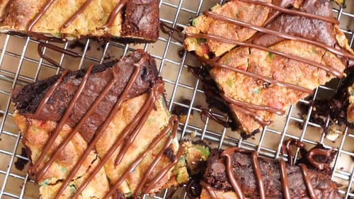 Baking brownies with added confetti sugar cookies, called a Brookie. Close up and panning across bro