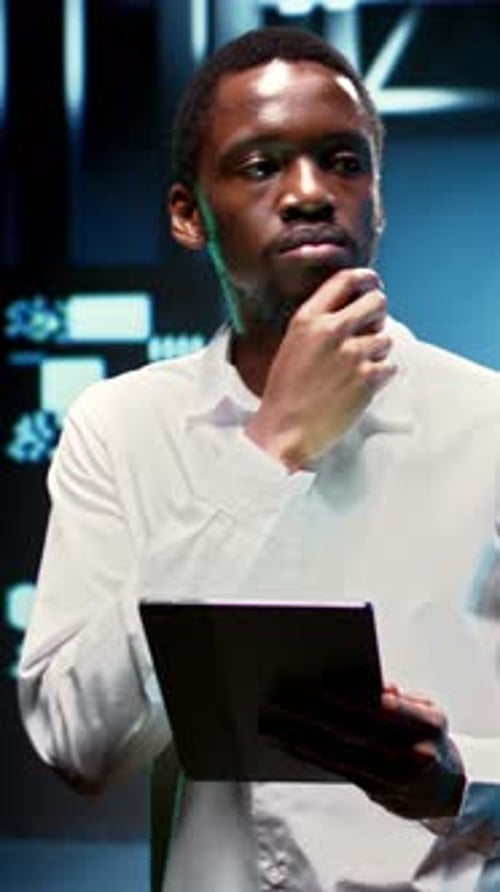 Man Holding Tablet in Server Room