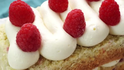 Delicious Cake with White Icing and Raspberries