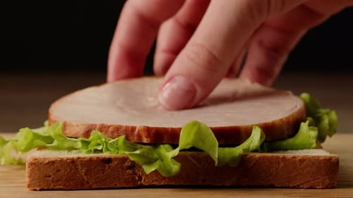 Adding Sandwich Ingredients Close Up