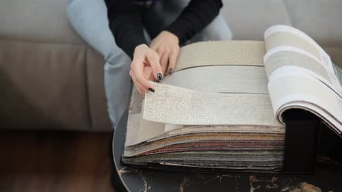 Woman Examines Fabric Swatches for Interior Design