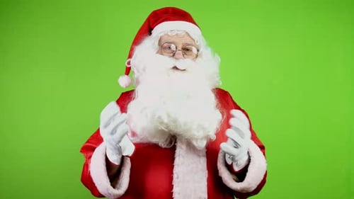 Man in Santa Costume Waving Against Green Screen