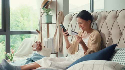 Woman Shops Online from Bed with Mobile