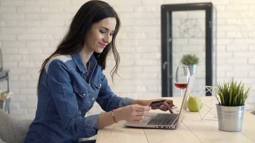 Woman Uses Laptop to Shop with Credit Card