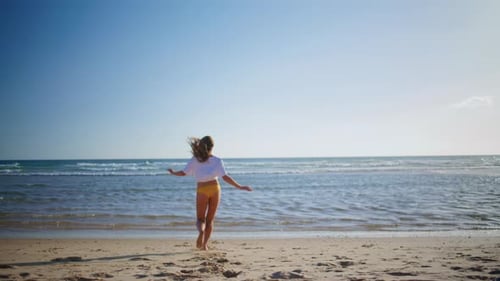 Sportswoman Legs Running Sand Beach Closeup Woman in Swimsuit Entering Ocean