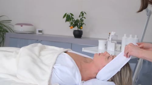 Relaxing Woman Receiving Facial Massage at Day Spa