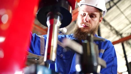 Worker Operating In Manual Lathe. Metalworker in the workshop.