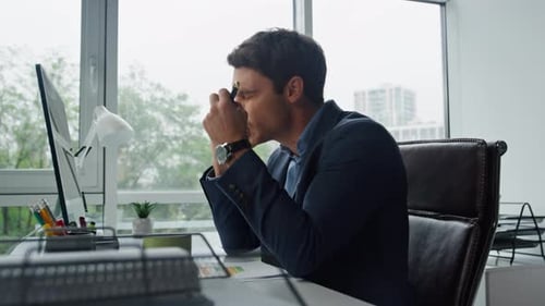 Nervous Manager Talking Mobile Phone in Office