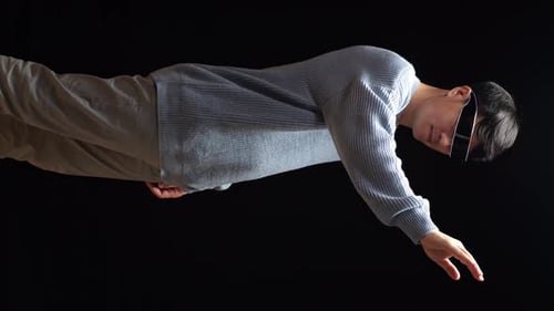 Side View Of Asian Man Touching And Swiping Virtual Reality With Hand While Using Futuristic Goggles