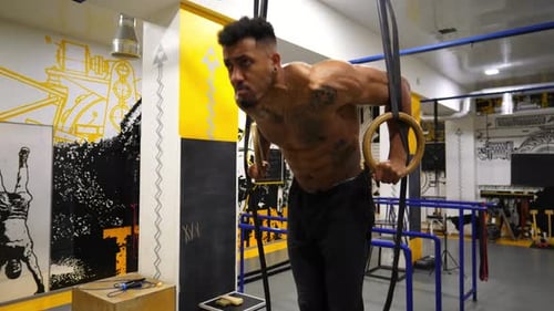 Strong African Athlete Doing Push Ups on Gymnastic Rings at Gym Muscular Afro American Sportsman