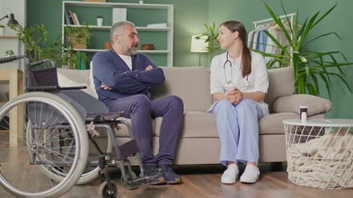 Man Talking with Healthcare Provider in Home Setting