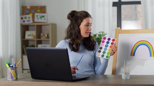 Woman teaching art class online from home studio