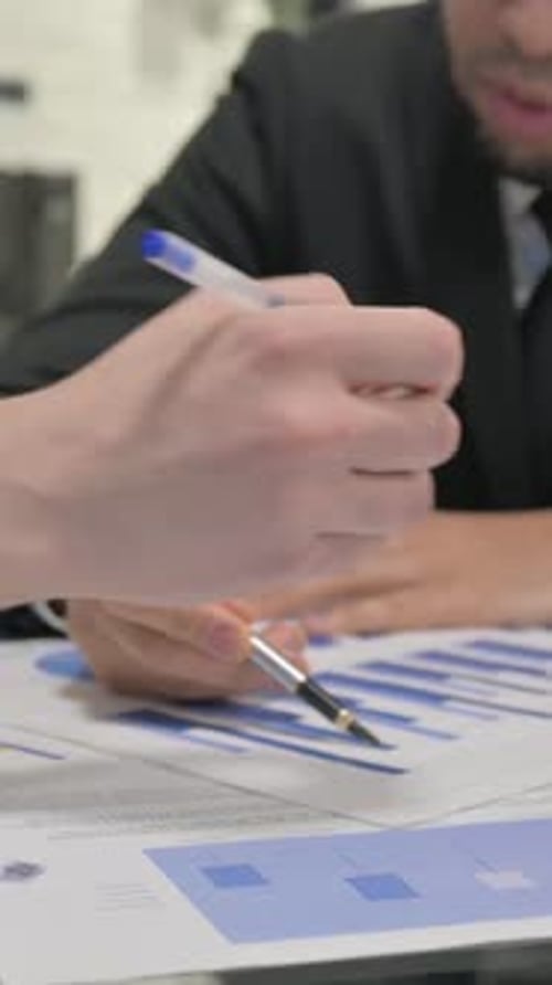 Close up of Businessmen Working on Documents, vertical video