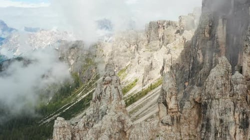 Alpine Mountains with Rocky Slopes Surrounded By Clouds