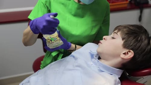 Gygienist Teaches a Child How to Care for His Mouth