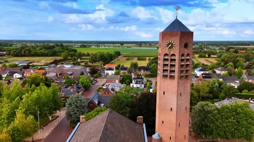 Flying closer to the clock tower of the Gothic building of Saint Lawrence church.