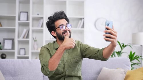 Man Video Calling on Phone in Living Room