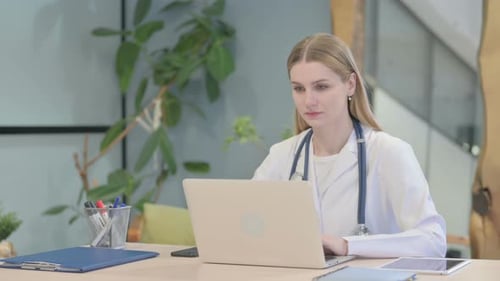 Female Doctor Working on Laptop in Office
