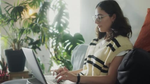 Woman Working on Laptop in Bright Home