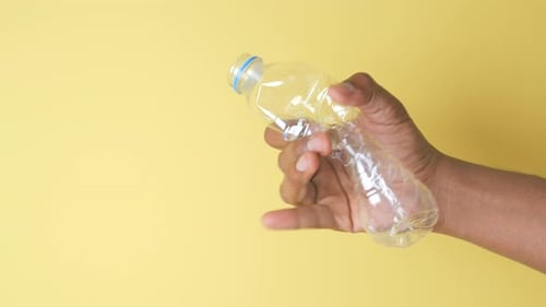 Hand Crushing Plastic Water Bottle