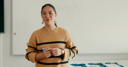 Teacher Addressing Students at the Front of Class