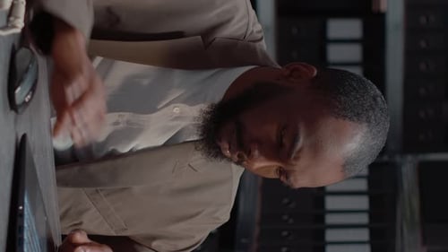 Man Working at Desk with Computer and Papers