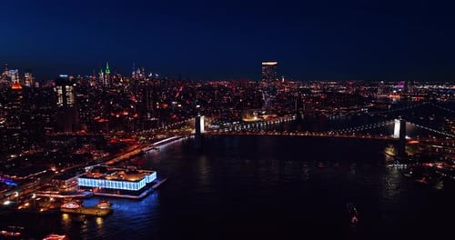 Multiple cars move by the roads of New York at night.