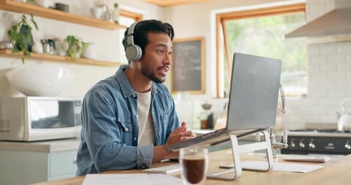 Man Talking on Laptop Video Call From Home