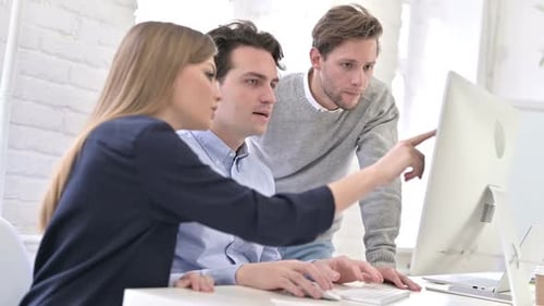 Team Working Together at Computer in Modern Office