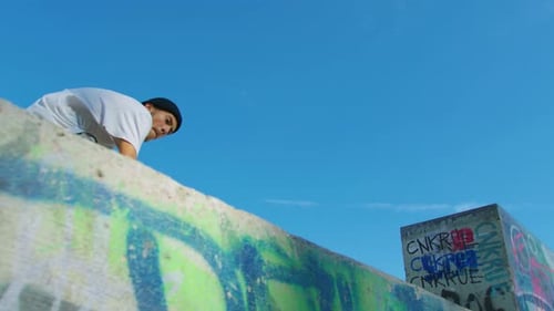 Skateboarder Performs Tricks in an Urban Skatepark