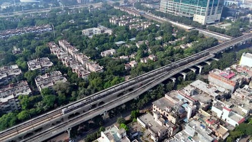 Drone shot of Noida Sector 16 in the morning, highlighting metro infrastructure, leafy