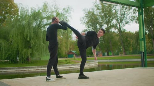 Martial Arts Training Choreographed Fight Exercises Beside Peaceful Lake European Male Practitioners