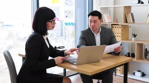 Professional Business Meeting with Report and Discussion in Modern Office