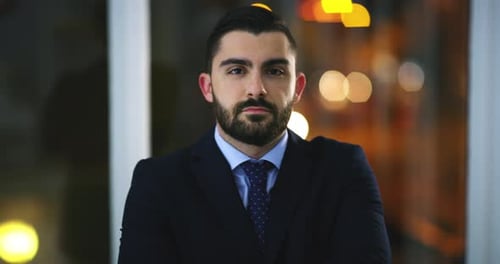 Face, confidence and business man in office, corporate company or workplace at night