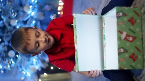 Excited Boy Opening Christmas Gift