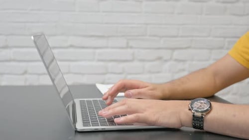 Close up of Hands Typing on Laptop