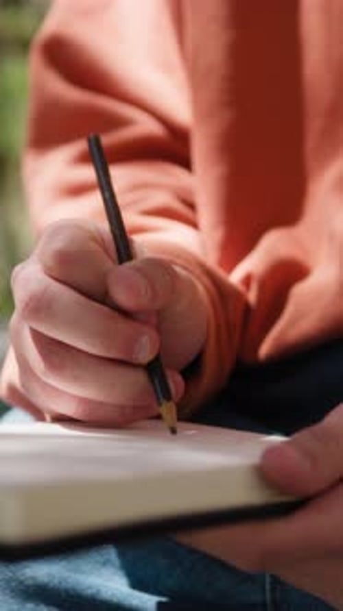 Hand Of A Man Is Inspired By Nature To Write A Novel Under The Tree