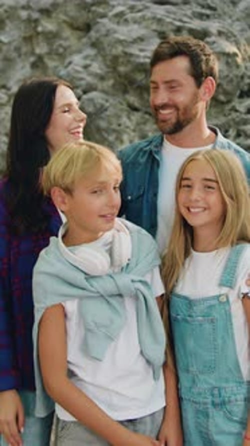 Happy Family Posing in front of Rocky Cliff