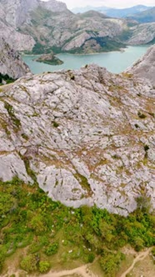 Approaching the bare rock in the range surrounding the lake. Nature of National park in Leon, Spain