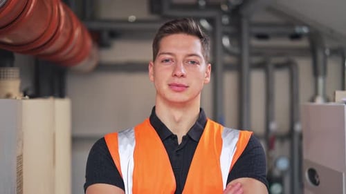 Young Engineer Standing Confidently in Industrial Setting