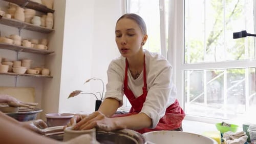 Young Artist Creates Pottery in Sunny Workshop Surrounded By Clay Pieces