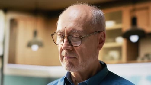 Senior Man Smiles Genuinely at Camera Indoors