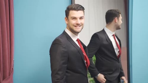 Well Dressed Man Applying Cologne in Mirror