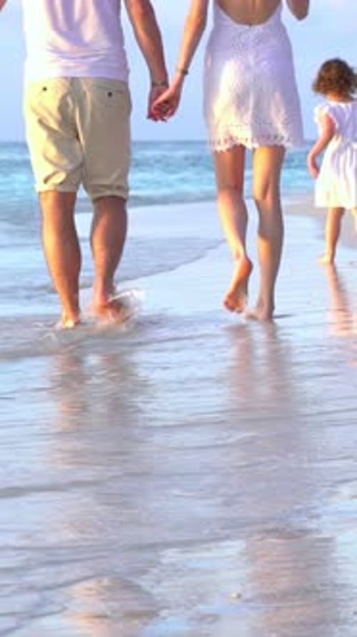 A Family Enjoying a Peaceful Walk on the Beach