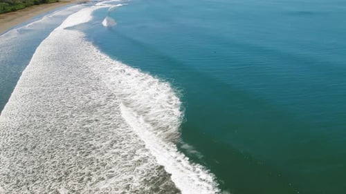 Pacific ocean waves rolling onto sandy shore at Ostional beach in Costa Rica
