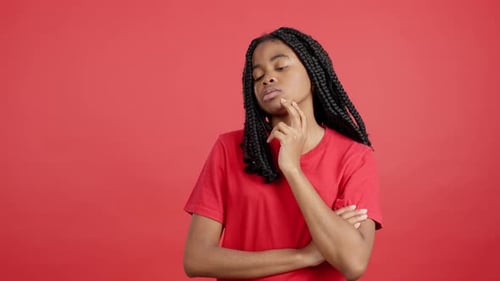 Pensive Woman with Braids Posing in Studio