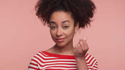 Woman Posing and Putting in Wireless Earbud