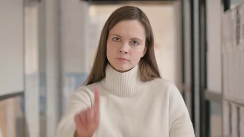 Woman Gesturing No in an Office Setting
