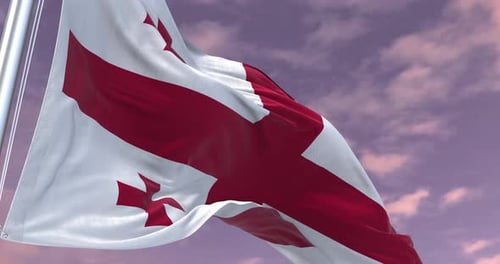 Waving Flag of Georgia with Cloudy Sky